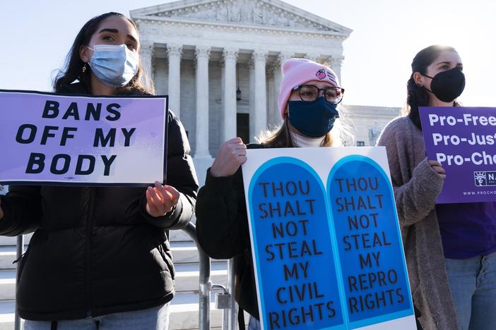 Caroline McDonald, left, a student at Georgetown University, Lauren Morrissey, with Catholics for Choice, and Pamela Huber, of Washington, join a abortion-rights rally outside the Supreme Court, Monday, Nov. 1, 2021.