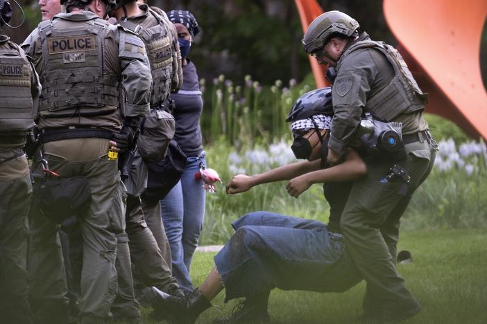 Police take demonstrators into custody on the campus of the Art Institute of Chicago after students established a protest encampment on the grounds on May 4.