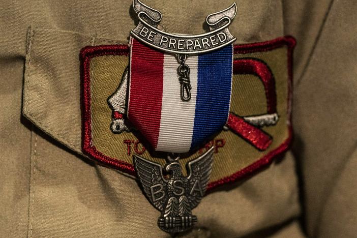An Eagle Scout Award is seen pinned to a uniform. After a lengthy sex-abuse scandal and bankruptcy, the Boy Scouts are changing their name to Scouting America.