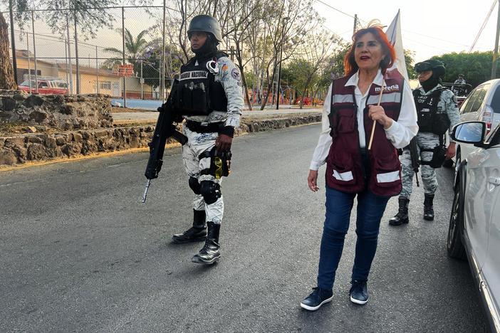 Following a rash of political assassinations, Magdalena Rosales campaigns with armed escorts in the city of Celaya in Mexico.
