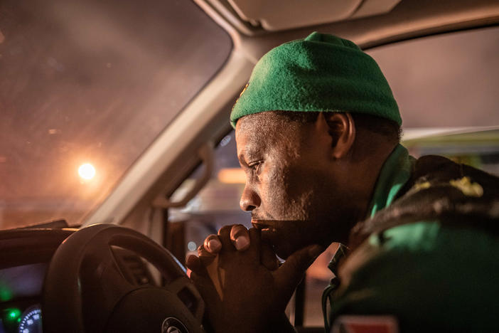 Paramedic Papinki Lebelo waits for a police escort before responding to an emergency call-out in the Red Zone neighborhood of Philippi East in Cape Town, South Africa. Due to a rise in attacks on paramedics, large parts of the city are only accessible to ambulance crews when they have a police escort. This severely delays response times.
