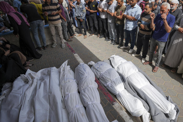 Mourners pray over the bodies of Palestinians who were killed in an Israeli airstrike in Nuseirat, at the Al Aqsa hospital in Deir al Balah, Gaza Strip, Sunday, May 19, 2024.