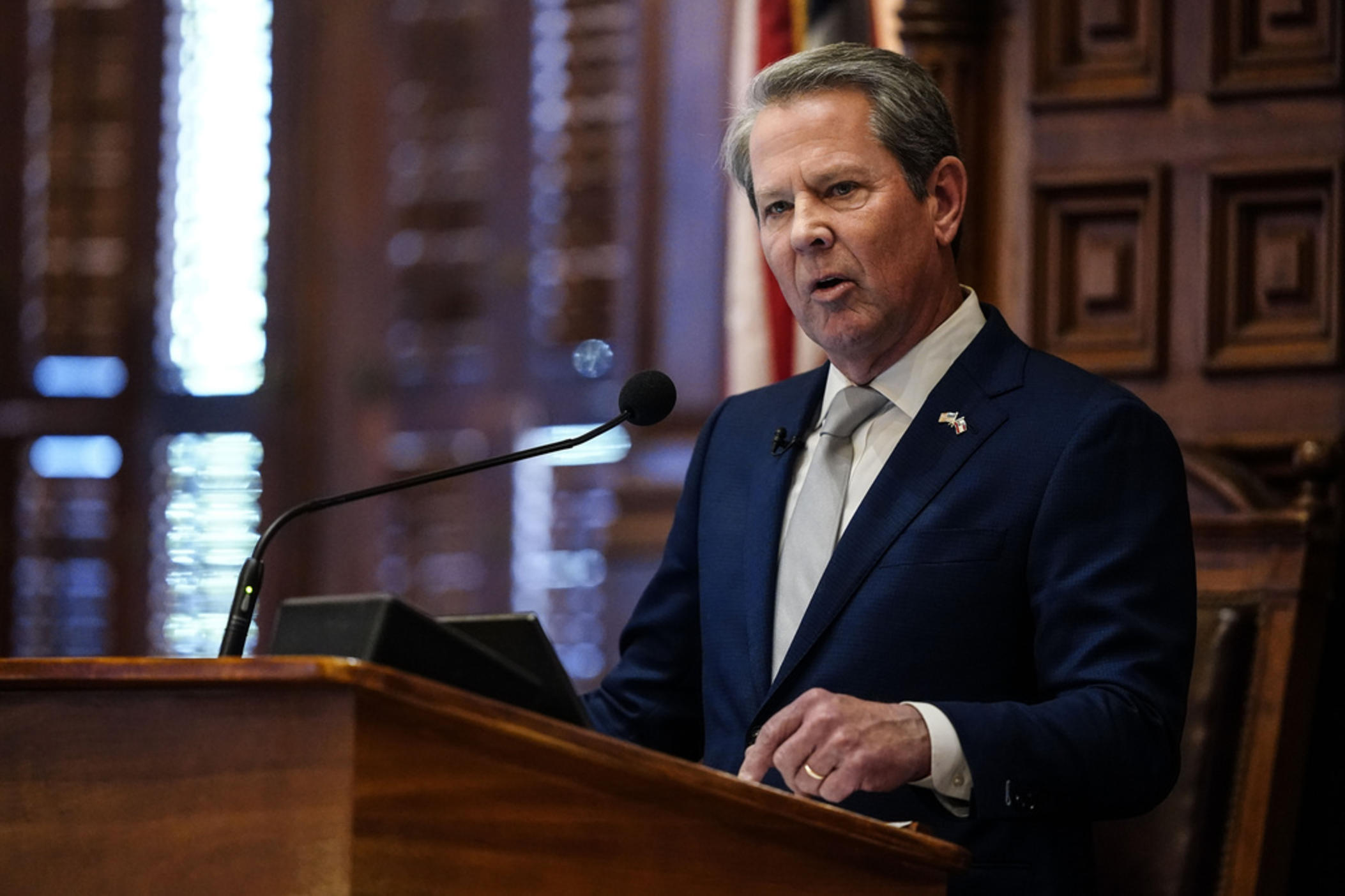 Governor Brian Kemp is shown speaking in the Georgia House of Representatives.