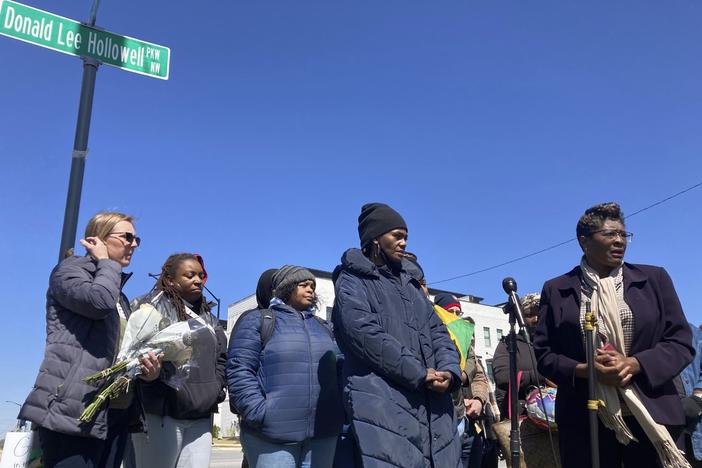 Valerie Handy-Carey stands with family members and city leaders on Donald Lee Hollowell Parkway on March 19, 2023, in Atlanta. Several months earlier, her daughter, Brittany Glover, was hit by a car and died while trying to cross the intersection. With pedestrian deaths in the U.S. at their highest in four decades, citizens across the nation are urging lawmakers to break from transportation spending focused on car culture. Atlanta, she said, needs to do more to protect pedestrians and cyclists.
