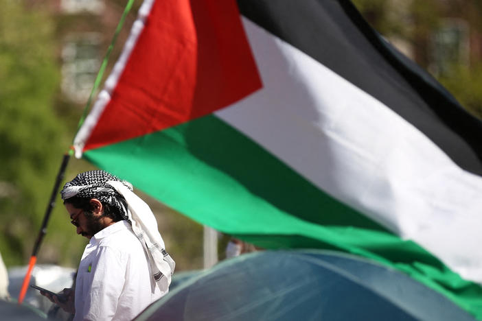 A pro-Palestinian protester stands among tents and a Palestinian flag at an encampment at Columbia University campus in New York earlier this month.