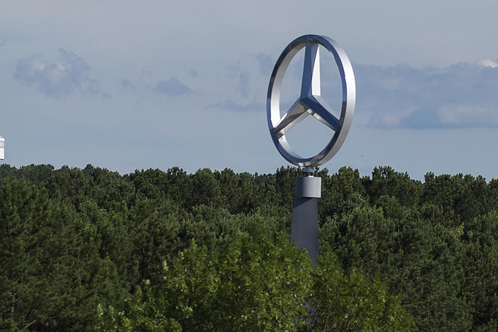 A giant Mercedes-Benz logo towers over the tree line at the Mercedes-Benz U.S. International plant in Vance, Ala., on June 7, 2017.