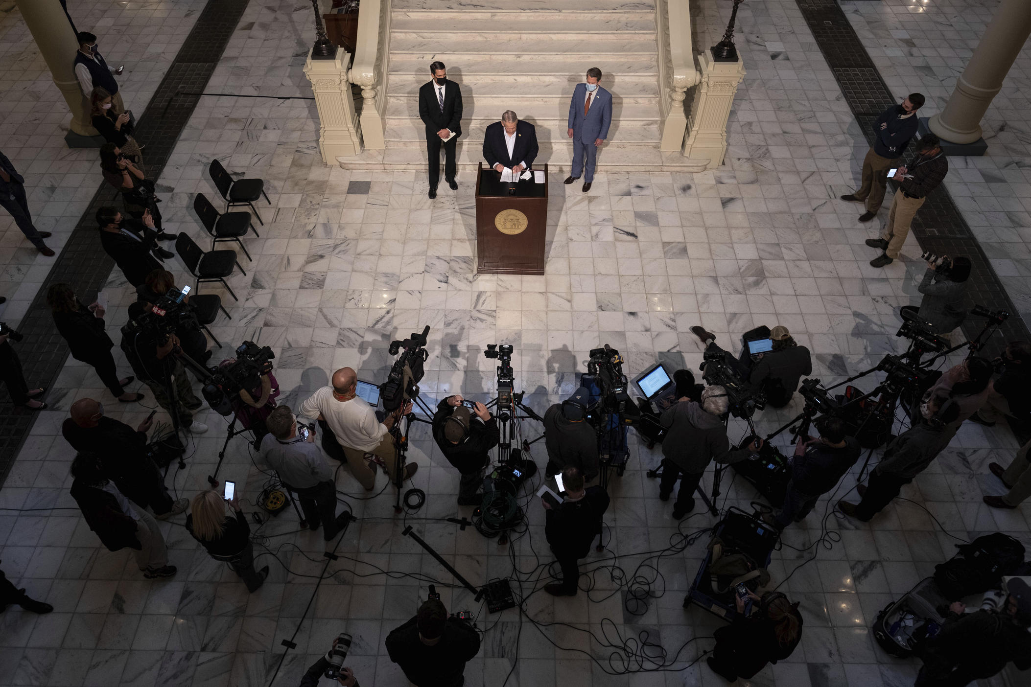 Georgia Speaker of the House David Ralston speaks to reporters with Lt. Gov. Geoff Duncan, left, and Gov. Brian Kemp, during a press conference Wednesday evening, Jan. 6, 2021, at the Georgia State Capitol in Atlanta, to condemn the breach of the U.S. Capitol. (AP Photo/Ben Gray)