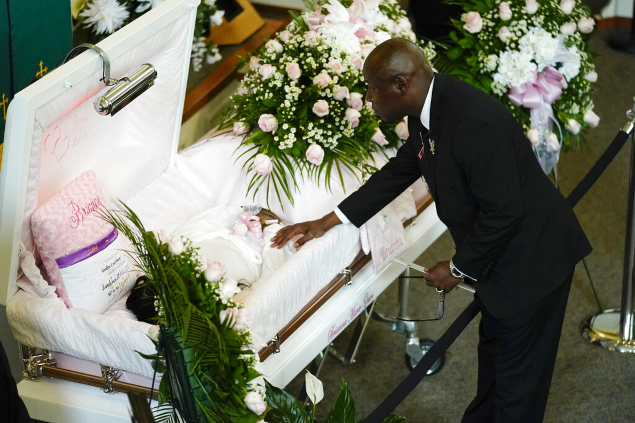 Attorney Ben Crump pays his respects during a funeral service for Brianna Grier Thursday, Aug. 11, 2022, in Atlanta. The 28-year-old Georgia woman died after she fell from a moving patrol car following her arrest.