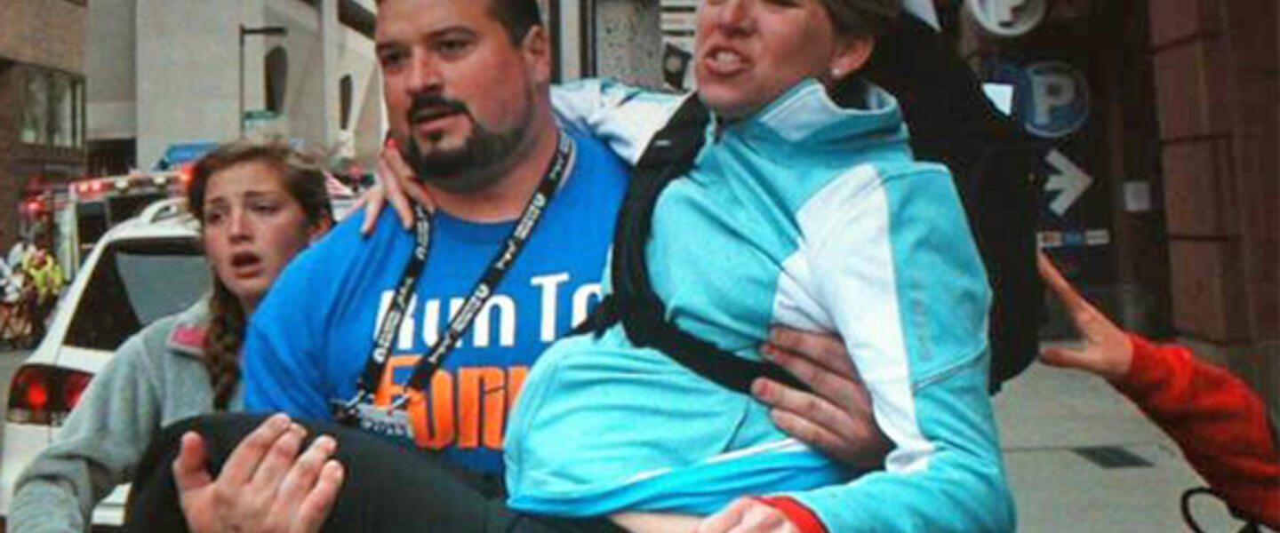 Former New Englands Patriot Joe Andruzzi helps a bombing victim. Photo courtesy Twitter. Former New Englands Patriot Joe Andruzzi helps a bombing victim. Photo courtesy Twitter.