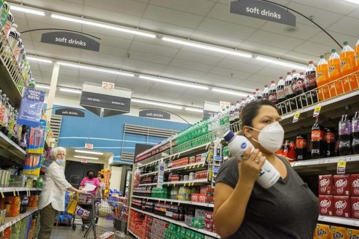 Macon-Bibb County officials might consider requiring people to wear masks in public soon after Gov. Brian Kemp's weekend order opened some restrictions. Shoppers in a grocery store in July 2020 are shown here with mask-wearing customs.