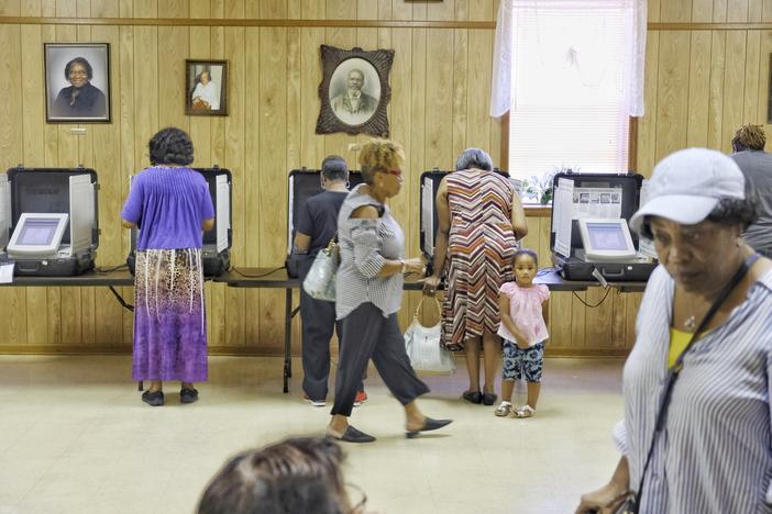 Voters inside of a polling location.