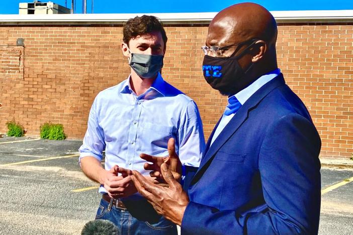 Rev. Raphael Warnock (right) rallies with Jon Ossoff (left) at a joint campaign stop in DeKalb County in Georgia’s U.S. Senate races on Oct. 3, 2020.