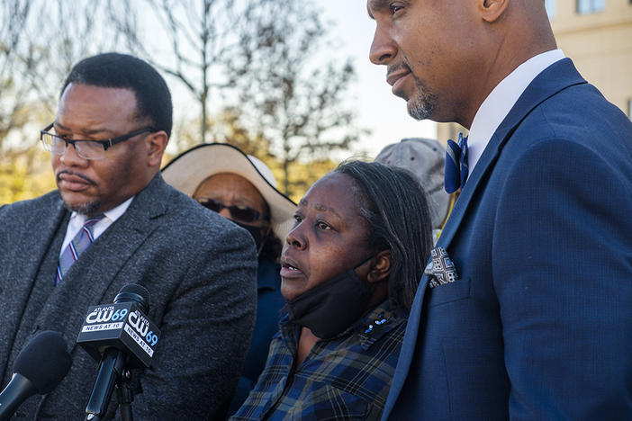 Eurie Lee Martin's sister Helen Gilbert, center, flanked by attorneys Francys Johnson, left, and Muwali Davis, right, during a press conference about the Georgia Supreme Court opinion on the immunity from prosecution granted to the former sheriff's deputies who killed Martin in 2017. 