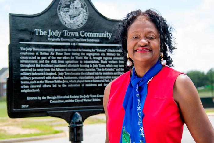 Woman standing in front of Jody Town historical marker