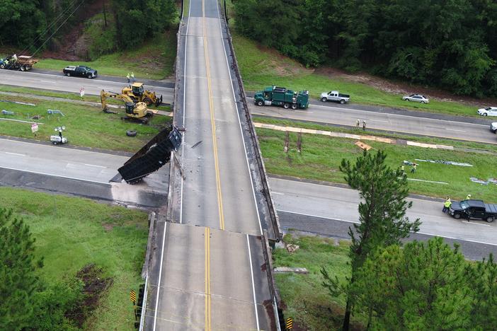 aerial photo showing a damaged highway overpass struck by a truck