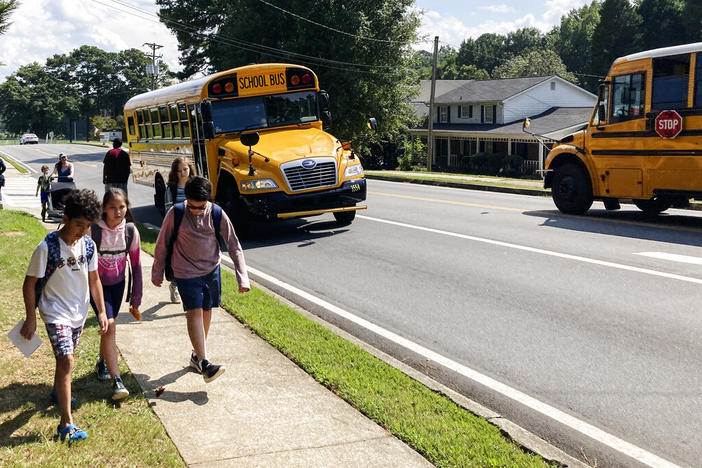 Children walk home from Camp Creek Elementary School in Lilburn, Ga., after school on Monday, Sept. 12, 2022. Polls show K-12 education trailing among voter concerns in Georgia this year as candidates talk more about inflation, the economy, abortion and guns.