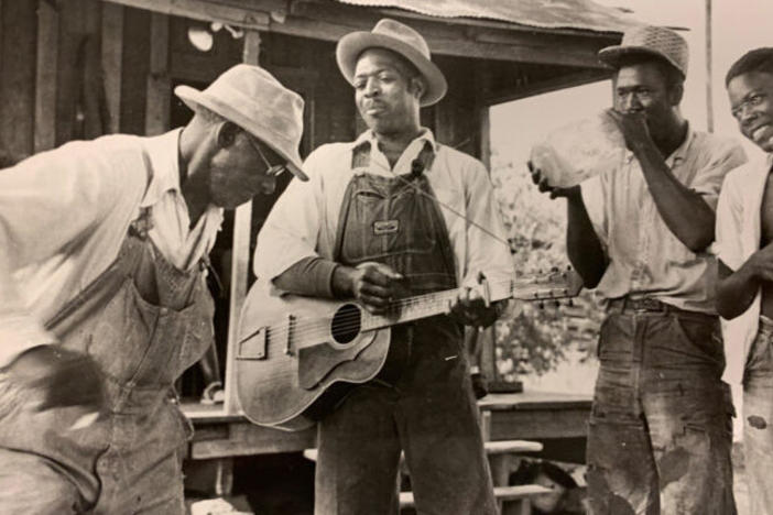 Four musicians in an old photograph.