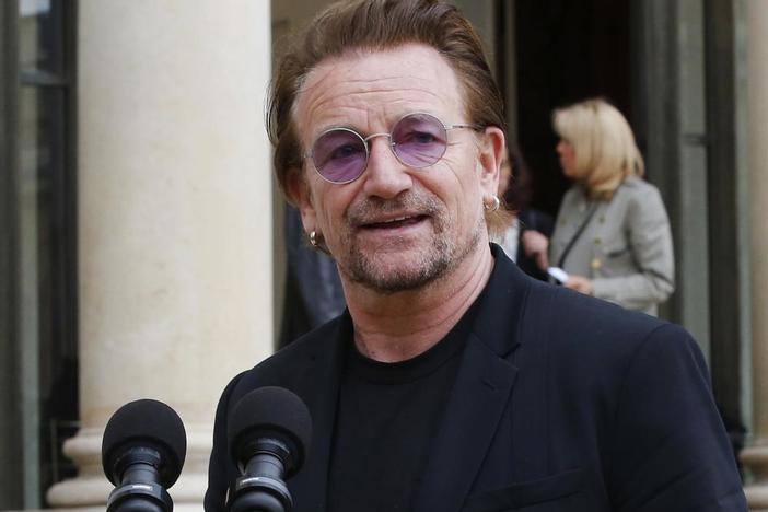 FILE - U2 singer Bono speaks to the media after a meeting at the Elysee Palace, in Paris, France on July 24, 2017. Bono's memoir "Surrender" planned for release on Nov. 1. (AP Photo/Michel Euler, File)