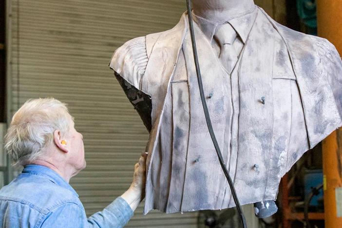 Metal fabricator Dale Smith with the bust of Dr. King. 