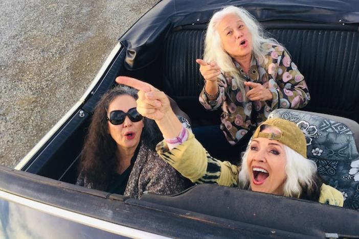 Members of the band Fanny in a convertable.