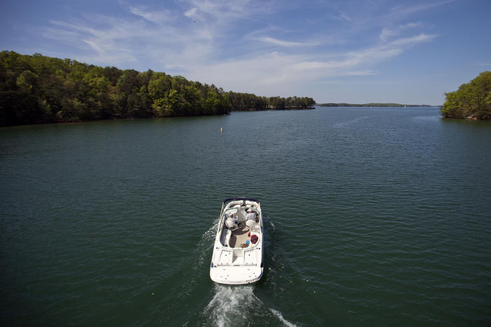 A boat passes along Lake Lanier, April 23, 2013, in Buford, Ga. Fashion designer Tameka Foster, the ex-wife of R&B singer Usher, is calling to drain Lake Lanier, Georgia's largest lake, where her son was fatally injured 11 years ago. Kile Glover, her 11-year-old son with Bounce TV chairman Ryan Glover, died in July 2012 after a personal watercraft struck the boy as he floated in an inner tube on the lake. 