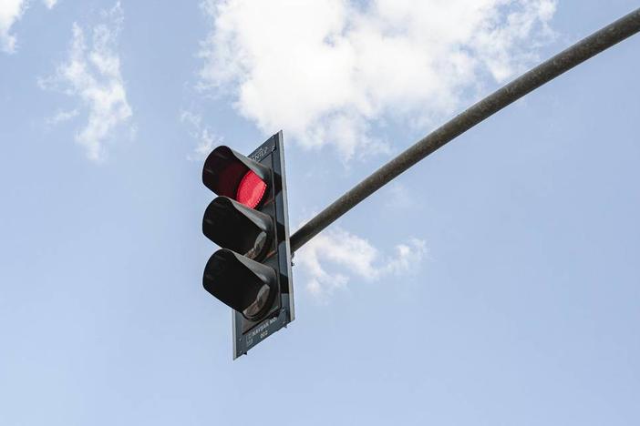 Under Georgia law, drivers cannot run a red light that is taking too long to turn green. Drivers can be penalized with a fine for disobeying a traffic signal. 
