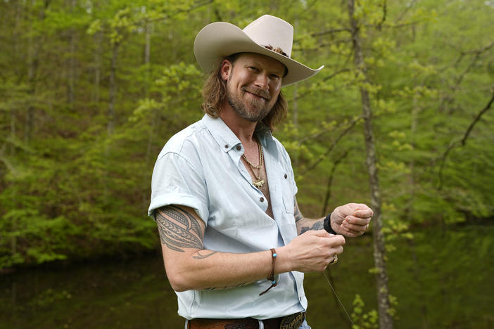 Brian Kelley poses for a portrait outside his cabin Wednesday, April 17, 2024, in Nashville, Tenn.