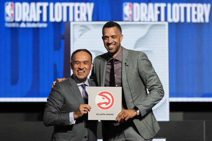 Atlanta Hawks general manager Landry Fields, right, and NBA Deputy Commissioner Mark Tatum pose for photos after Tatum announced that the Hawks had won the first pick in the NBA draft, during the draft lottery in Chicago, Sunday, May 12, 2024. 