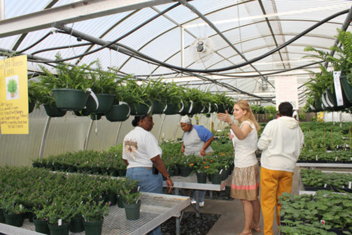 Colquitt County High School Teacher Adrienne Smith helps customers at a FFA Plant Sale.  Photo: www.theblackandgold.org