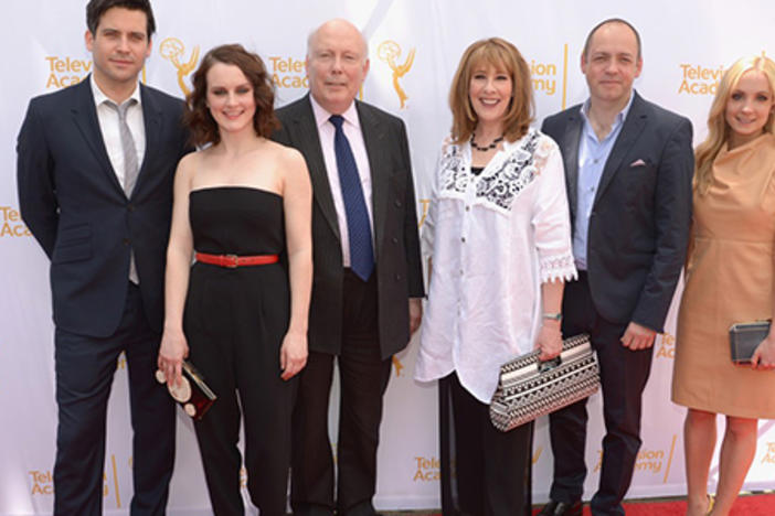 Downton Abbey Cast members and producers Julian Fellowes and Gareth Naeme mug for cameras before their webast.