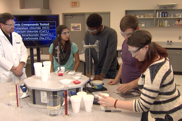 The students perform the coffee cup calorimetry experiment.