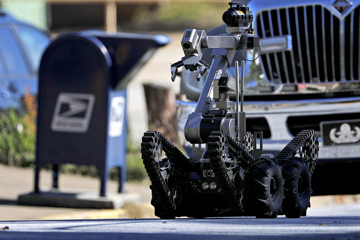 A robot exits a U.S. post office facility as law enforcement officials investigate a report that a suspicious package was found in Atlanta. The FBI said authorities recovered the suspicious package that was addressed to the cable network CNN. 