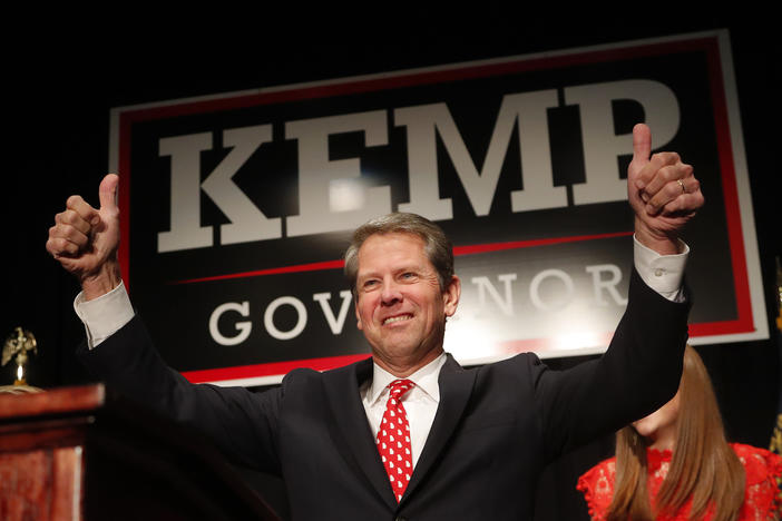 Brian Kemp gives a thumbs-up to supporters, Wednesday, Nov. 7, 2018, in Athens, Ga.