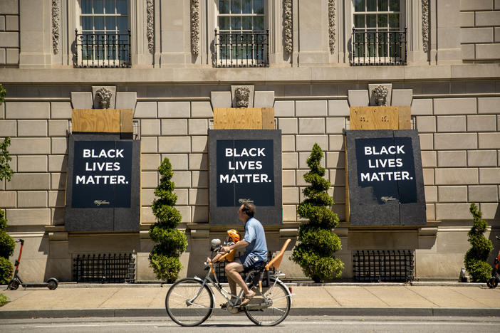 The words Black Lives Matter are painted on boarded up windows of the Hay Adams Hotel, a site of protests, near the White House in Washington.