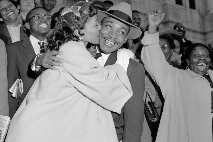The Rev. Martin Luther King Jr. is welcomed with a kiss by his wife Coretta after leaving court in Montgomery, Ala., March 22, 1956.