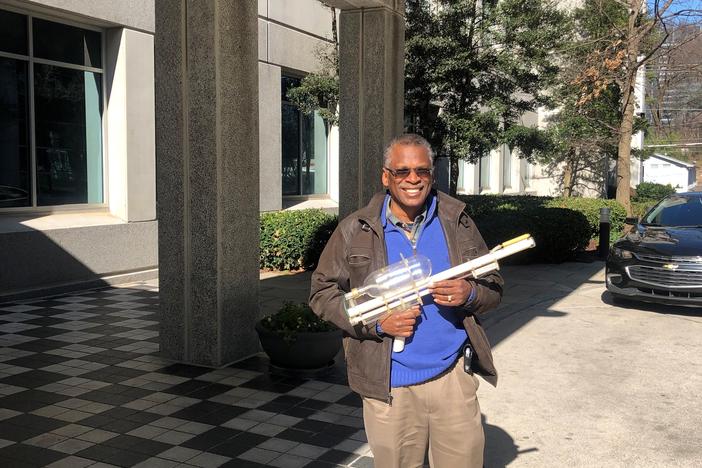 Dr. Lonnie Johnson pictured with his prototype for the Super Soaker.