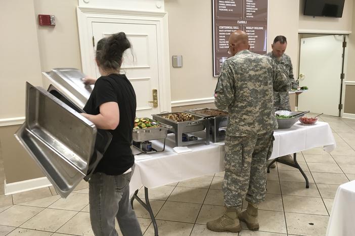 Saralyn Collins with Grow Restaurant serves lunch to members of the Georgia Department of Defense's 5th Brigade at Vineville Methodist Church.