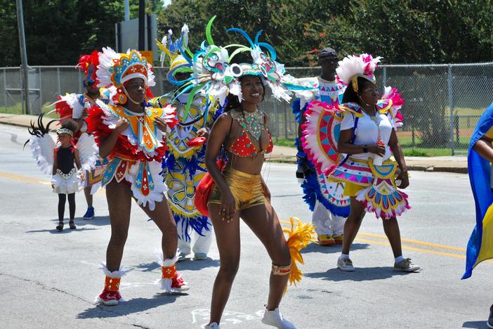 Men and women march in 2018 Juneteenth parade in Atlanta.