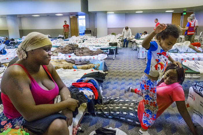 Shayvonda Edwards, left, in a Red Cross shelter in Albany last October, had only settled down in Albany after moving from Fort Lauderdale when her apartment was destroyed by Hurricane Michael, leaving her homeless. 