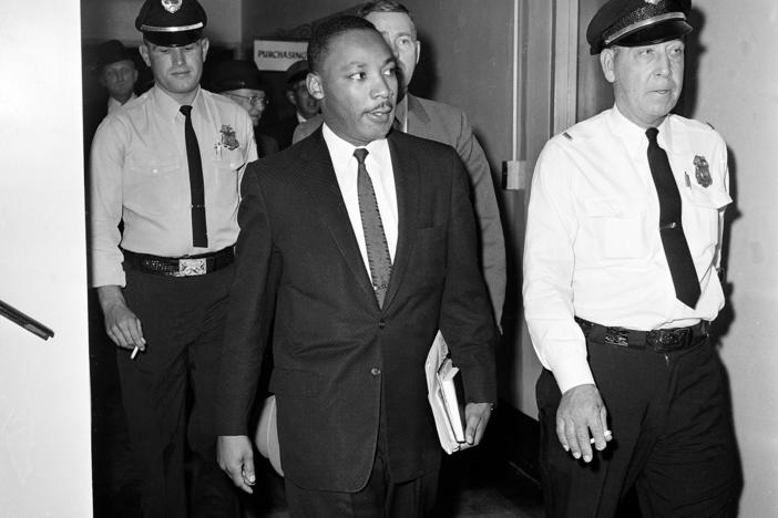  In this Oct. 25, 1960 file photo, Dr. Martin Luther King Jr. leaves court after being given a four-month sentence in Decatur, Ga., for taking part in a lunch counter sit-in at Rich's department store. 