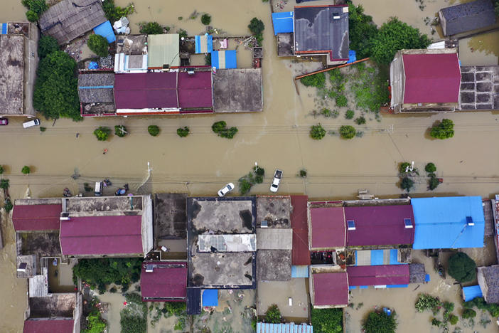 An aerial photo shows the extent of flooding in Guzhen Town of Lu'an City in eastern China's Anhui province on July 20.