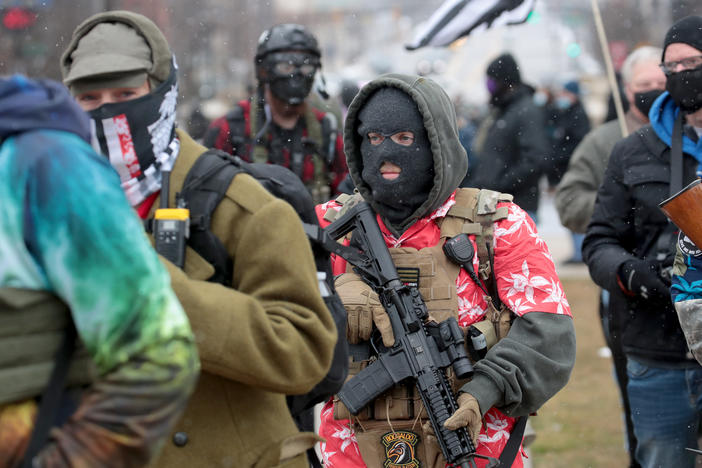 Armed demonstrators protest outside of the Michigan state capital building on Sunday in Lansing, Michigan.