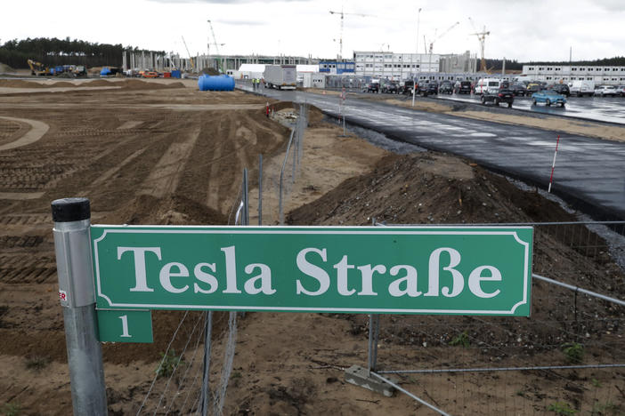A street sign says "Tesla Street 1" in front of the construction site of the Tesla Gigafactory near Berlin. The electric automaker plans to start building cars this summer at its first European production site.