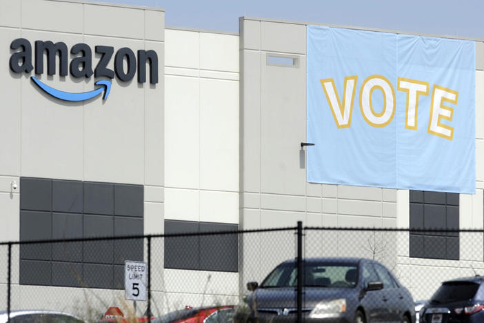 A banner encourages workers to vote in a union election at Amazon's warehouse in Bessemer, Ala.