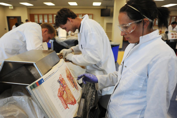 In this 2009 photo, Stephen Cox (left), Mike Forte (center), and Maria Gallo (right), all medical students then, were busy studying a cadaver in the lab at Rocky Vista University's Parker, Colo., campus. Rocky Vista, a for-profit institution, last month received the green light for an accredited satellite campus in Billings, Mont.