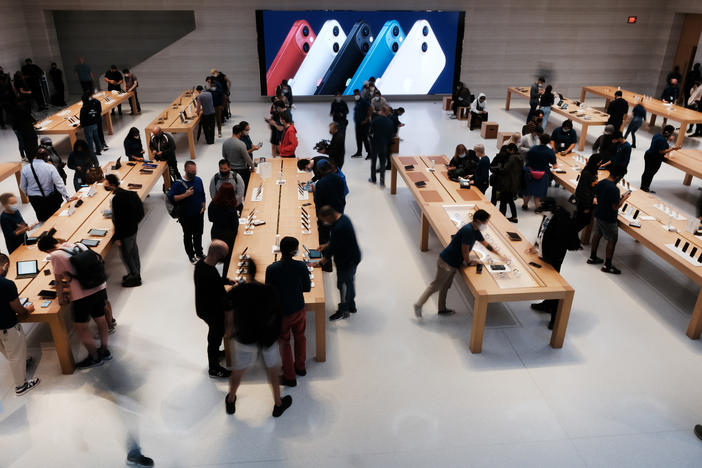 People shop at the Fifth Avenue Apple Store in September in New York City. Apple says customers who want to repair their own devices will be able to buy the parts and tools to do so for certain products starting early next year.