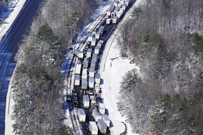 Drivers wait for the traffic to be cleared as cars and trucks are stranded on sections of Interstate 95 Tuesday Jan. 4, 2022, in Carmel Church, Va. Close to 48 miles of the Interstate was closed due to ice and snow.