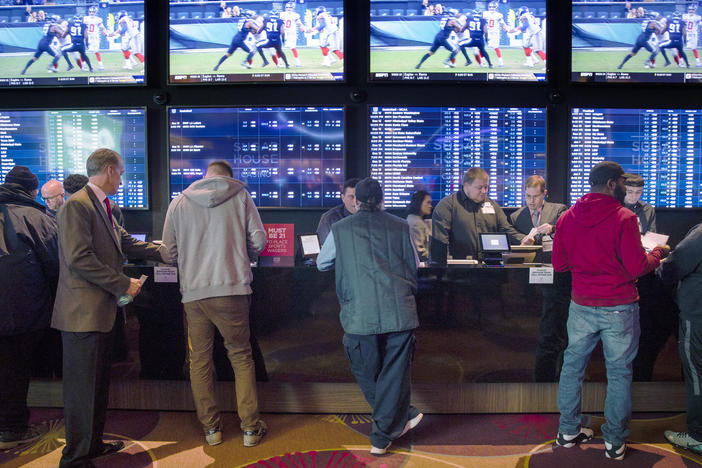 Gamblers place bets in the temporary sports-betting area at the SugarHouse Casino in Philadelphia on Dec. 13, 2018. An estimated 17.6 million people are expected to place a bet on Sunday's Super Bowl online or in person at a sportsbook.