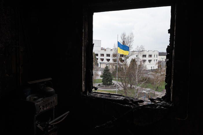 A Ukrainian national flag is seen through a window of a destroyed apartment, on Thursday in Borodianka, Ukraine.