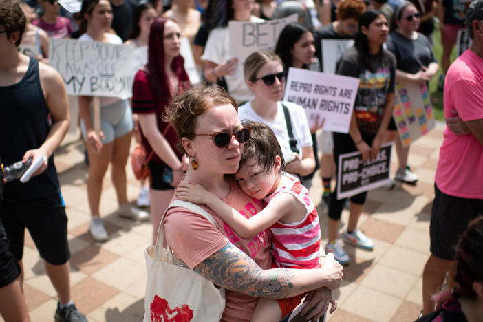 An attendee holds her child during A Texas Rally for Abortion Rights at Discovery Green in Houston, Texas, on May 7. Recently passed laws make abortion illegal after about six weeks into a pregnancy.